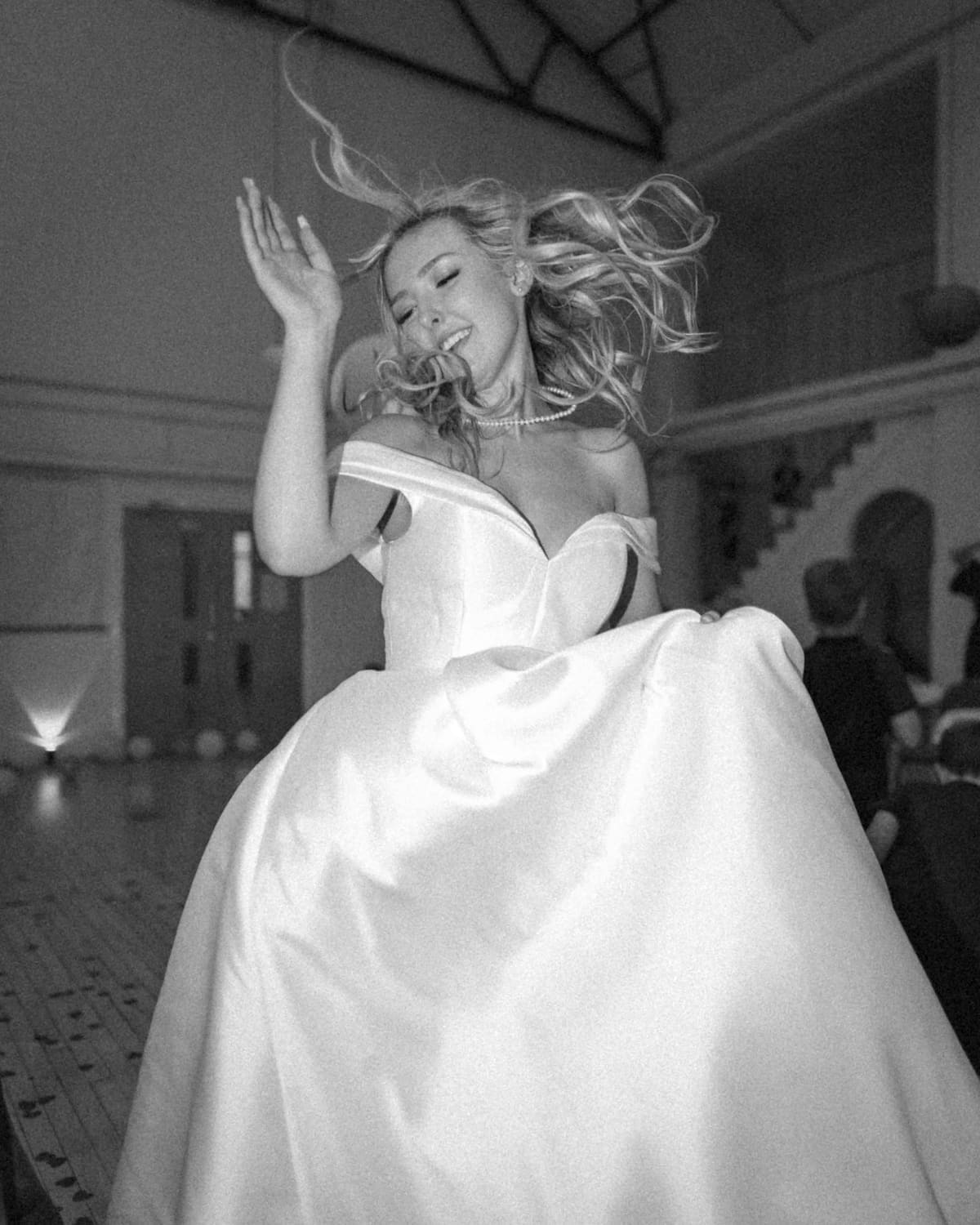 A bride mid-dance, hair flying, lost in the music.