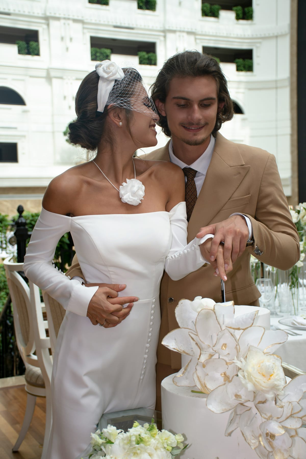 A couple dressed in wedding gown and suit